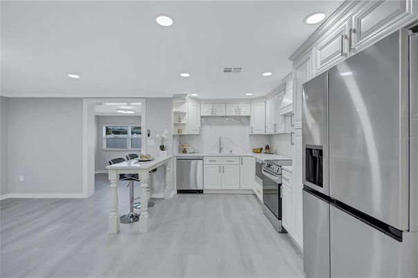 Interior, Kitchen, Marble Walls, Recessed Lighting, Stainless Steel Appliances, Wood Texture Flooring