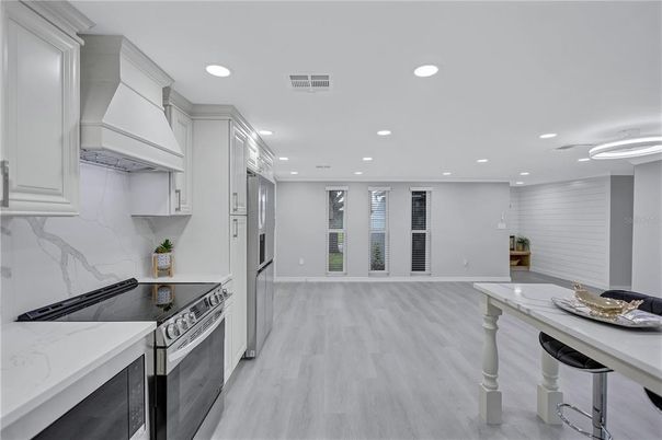 Interior, Kitchen, Marble Walls, Recessed Lighting, Stainless Steel Appliances, Wood Texture Flooring