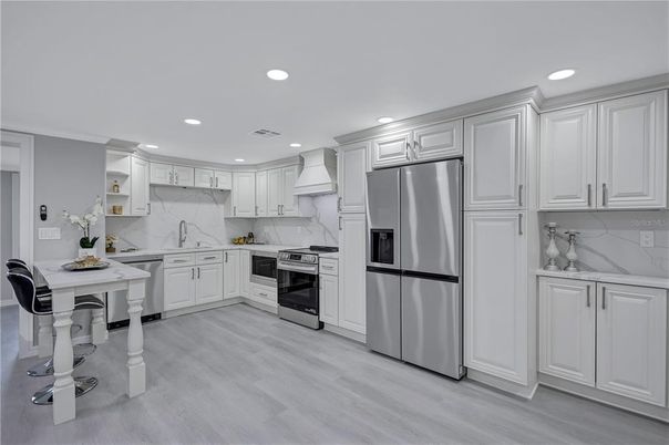 Interior, Kitchen, Marble Walls, Recessed Lighting, Stainless Steel Appliances, Wood Texture Flooring