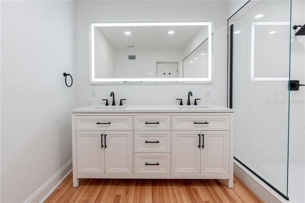 Bathroom, Dual Sink Vanities, Glass Shower, Interior, Recessed Lighting, Wood Texture Flooring