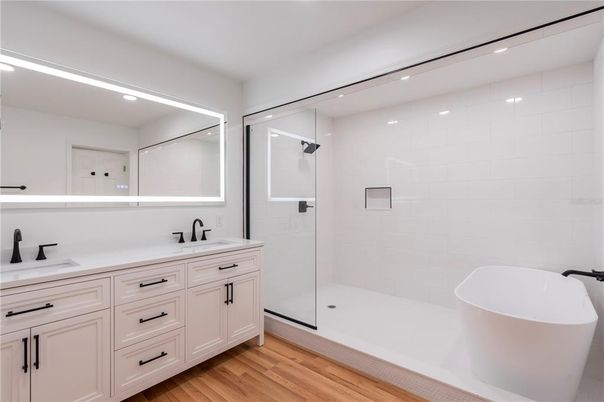 Bathroom, Dual Sink Vanities, Free Standing Baths, Glass Shower, Interior, Recessed Lighting, Wood Texture Flooring