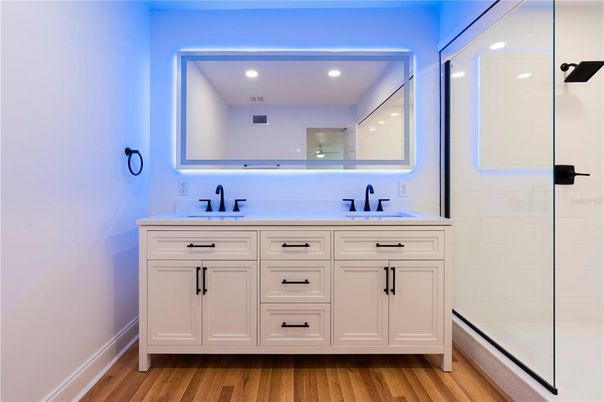 Bathroom, Dual Sink Vanities, Glass Shower, Interior, Recessed Lighting, Wood Texture Flooring