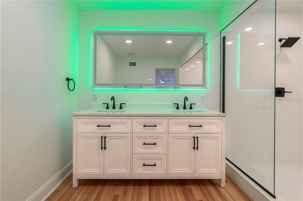 Bathroom, Dual Sink Vanities, Glass Shower, Interior, Recessed Lighting, Wood Texture Flooring