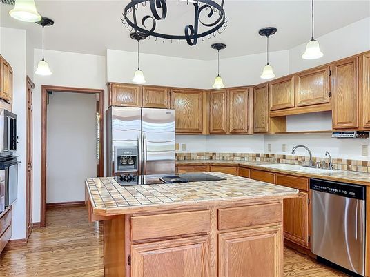Interior, Kitchen, Pendant Lights, Stainless Steel Appliances, Tile Countertops, Wood Texture Flooring
