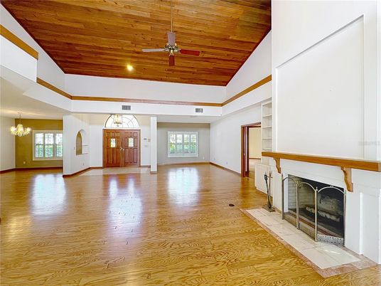 Chandelier, Empty room, Fireplace, Interior, Recessed Lighting, Wooden Ceilings, Wood Texture Flooring