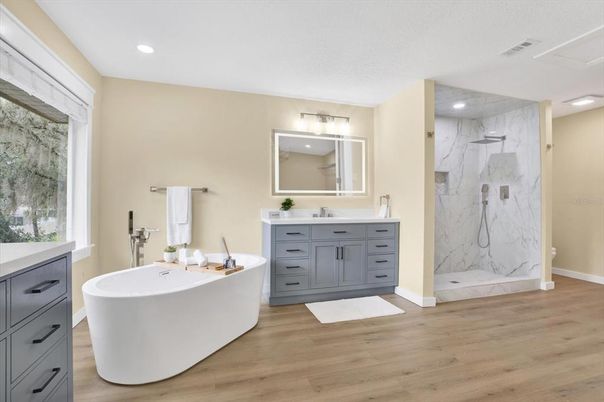 Bathroom, Dual Sink Vanities, Free Standing Baths, Glass Shower, Interior, Marble, Marble Walls, Recessed Lighting, Wood Texture Flooring