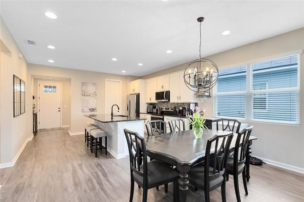 Chandelier, Dining room, Interior, Kitchen, Recessed Lighting, Stainless Steel Appliances, Wood Texture Flooring