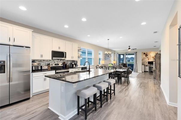 Chandelier, Dining room, Interior, Kitchen, Pendant Lights, Recessed Lighting, Stainless Steel Appliances, Wood Texture Flooring