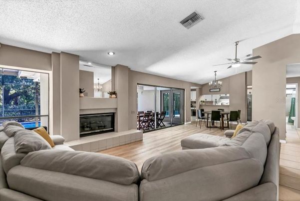 Chandelier, Dining room, Fireplace, Interior, Kitchen, Living room, Recessed Lighting, Wood Texture Flooring