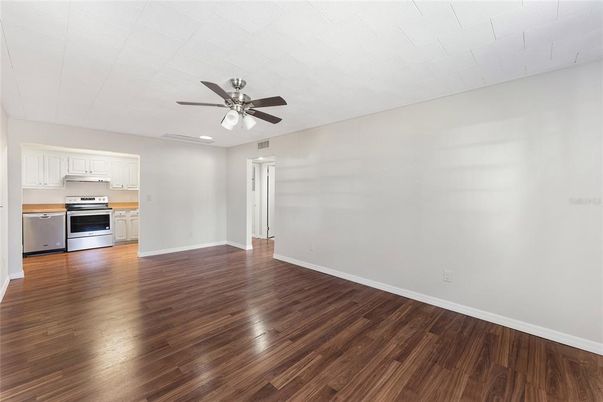 Empty room, Interior, Kitchen, Recessed Lighting, Stainless Steel Appliances, Wood Texture Flooring