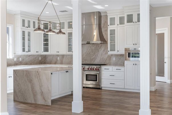 Interior, Kitchen, Marble Walls, Pendant Lights, Recessed Lighting, Stainless Steel Appliances, Wood Texture Flooring