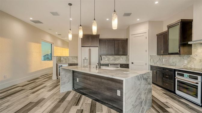 Interior, Kitchen, Marble Walls, Pendant Lights, Recessed Lighting, Stainless Steel Appliances, Wood Texture Flooring