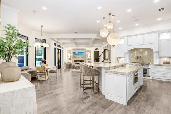 Chandelier, Dining room, Interior, Kitchen, Living room, Pendant Lights, Recessed Lighting, Stainless Steel Appliances, Wood Texture Flooring