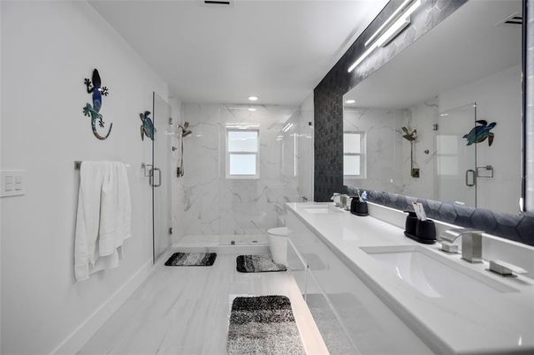 Bathroom, Dual Sink Vanities, Glass Shower, Interior, Marble, Marble Walls, Recessed Lighting