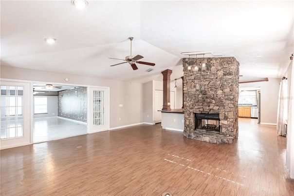 Empty room, Fireplace, Interior, Recessed Lighting, Stone Walls, Wood Texture Flooring