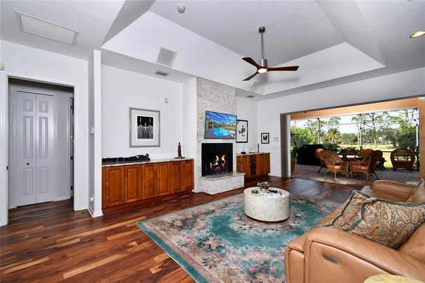 Dining room, Fireplace, Interior, Living room, Recessed Lighting, Stone Walls, Wood Texture Flooring