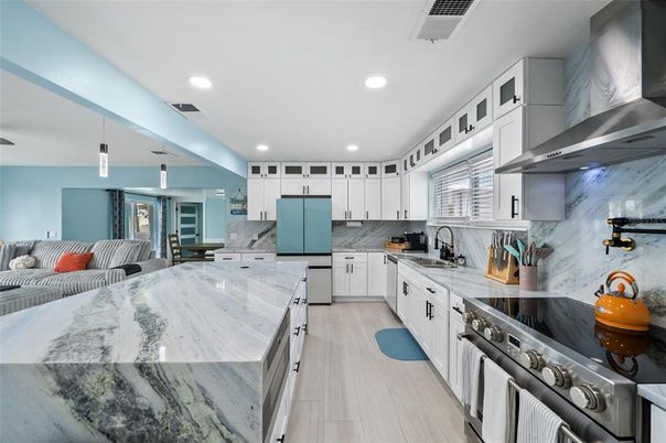 Interior, Kitchen, Marble Walls, Pendant Lights, Recessed Lighting, Stainless Steel Appliances, Wood Texture Flooring
