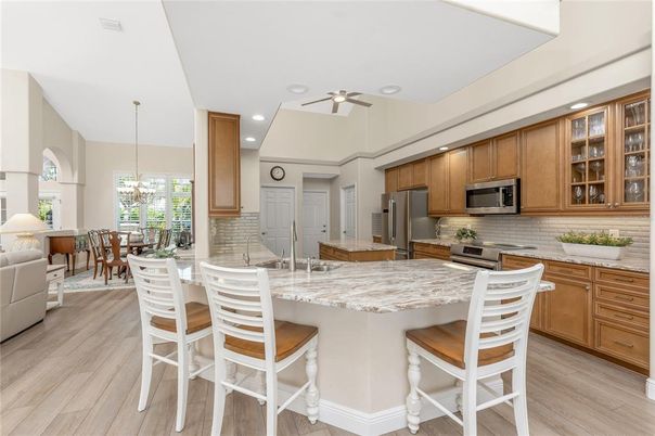 Chandelier, Dining room, Interior, Kitchen, Pendant Lights, Recessed Lighting, Stainless Steel Appliances, Wood Texture Flooring