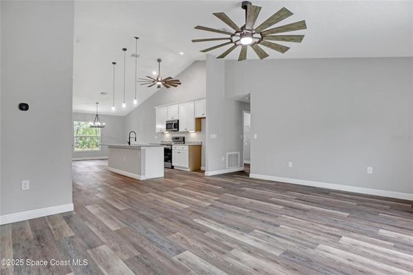 Empty room, Interior, Kitchen, Pendant Lights, Recessed Lighting, Stainless Steel Appliances, Wood Texture Flooring