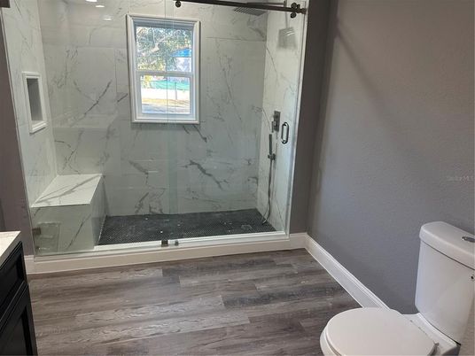 Bathroom, Glass Shower, Interior, Marble Walls, Wood Texture Flooring