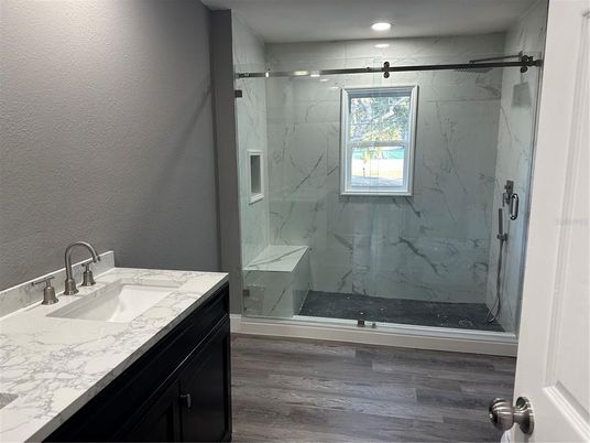 Bathroom, Glass Shower, Interior, Marble Walls, Recessed Lighting, Wood Texture Flooring