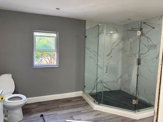 Bathroom, Glass Shower, Interior, Marble Walls, Wood Texture Flooring