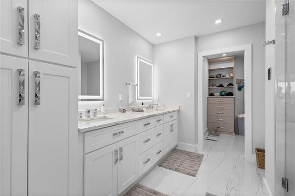 Bathroom, Dual Sink Vanities, Interior, Marble, Recessed Lighting, Walk-in Closets