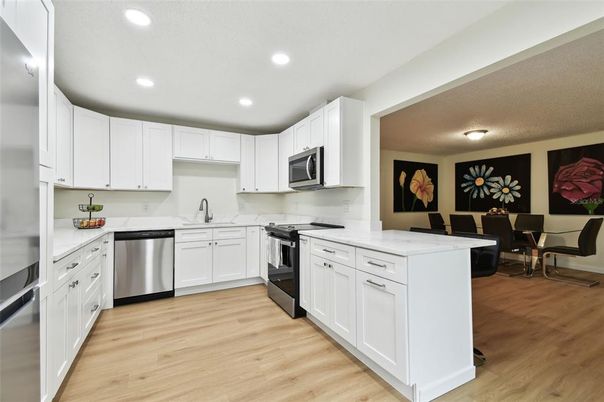 Dining room, Interior, Kitchen, Recessed Lighting, Stainless Steel Appliances, Wood Texture Flooring