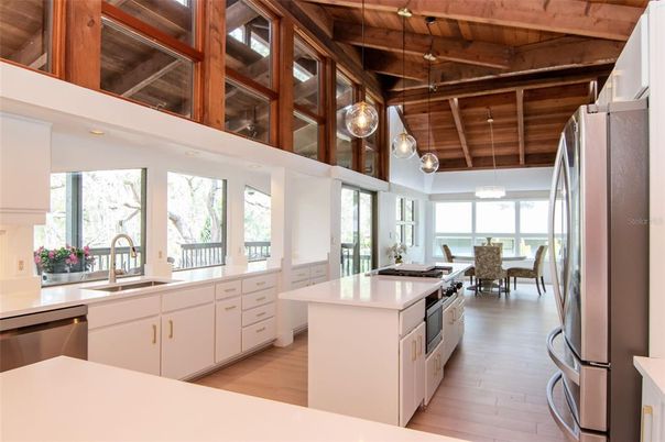 Dining room, Interior, Kitchen, Pendant Lights, Stainless Steel Appliances, Water, Wooden Beams, Wooden Ceilings, Wood Texture Flooring
