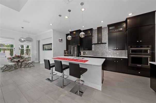 Dining room, Interior, Kitchen, Pendant Lights, Recessed Lighting, Stainless Steel Appliances, Wood Texture Flooring