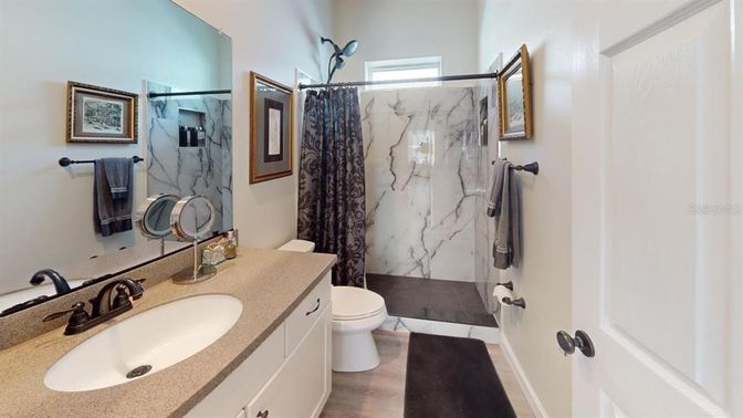 Bathroom, Glass Shower, Interior, Marble Walls, Wood Texture Flooring