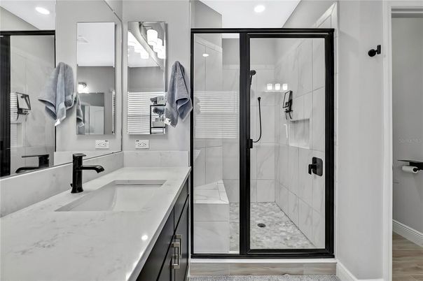 Bathroom, Dual Sink Vanities, Glass Shower, Interior, Recessed Lighting, Wood Texture Flooring