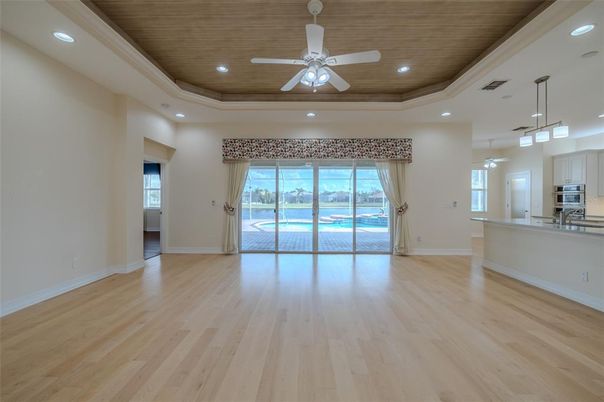 Empty room, Interior, Kitchen, Pendant Lights, Recessed Lighting, Stainless Steel Appliances, Wooden Ceilings, Wood Texture Flooring