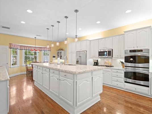 Dining room, Interior, Kitchen, Pendant Lights, Recessed Lighting, Stainless Steel Appliances, Wood Texture Flooring