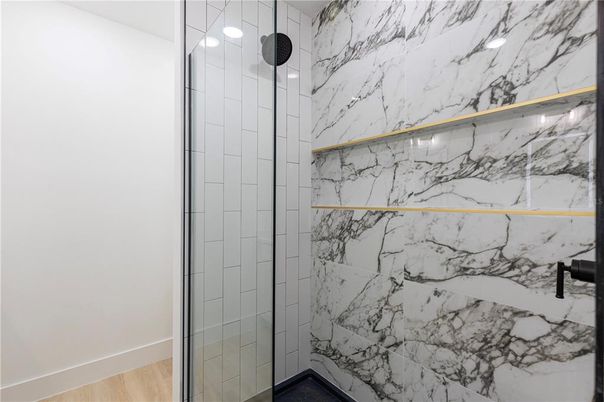 Bathroom, Glass Shower, Interior, Marble Walls, Wood Texture Flooring
