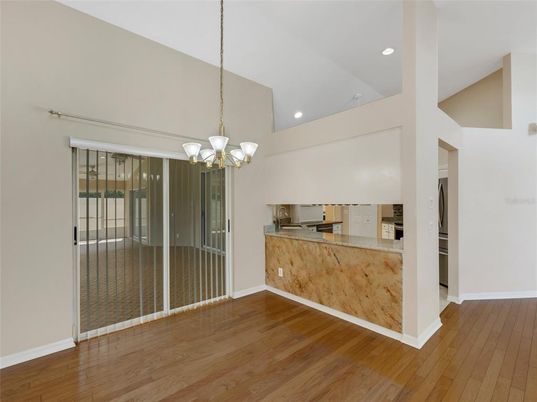 Chandelier, Empty room, Interior, Kitchen, Recessed Lighting, Stainless Steel Appliances, Wood Texture Flooring