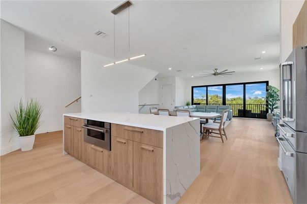 Dining room, Interior, Kitchen, Pendant Lights, Recessed Lighting, Stainless Steel Appliances, Water, Wood Texture Flooring
