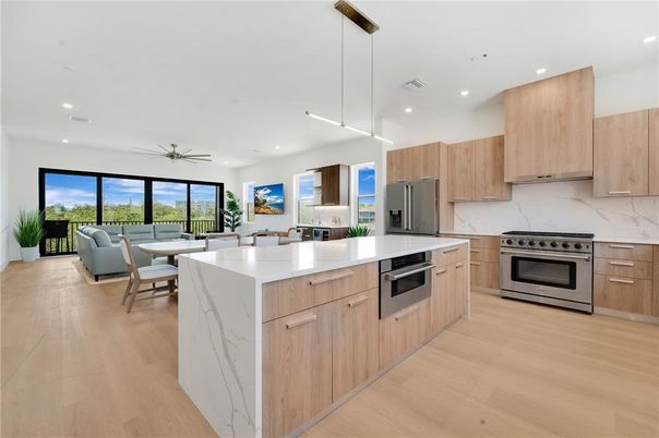 Dining room, Interior, Kitchen, Living room, Pendant Lights, Recessed Lighting, Stainless Steel Appliances, Water, Wood Texture Flooring