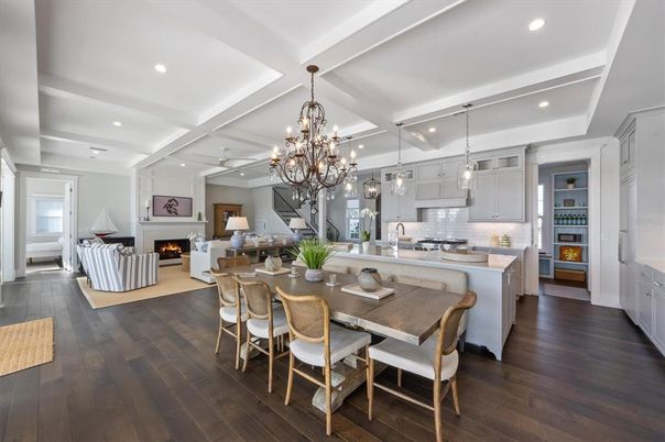 Chandelier, Dining room, Fireplace, Interior, Kitchen, Living room, Pendant Lights, Recessed Lighting, Stainless Steel Appliances, Wood Texture Flooring