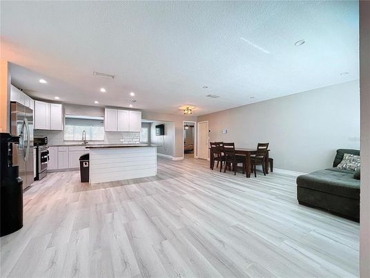 Dining room, Interior, Kitchen, Recessed Lighting, Stainless Steel Appliances, Wood Texture Flooring