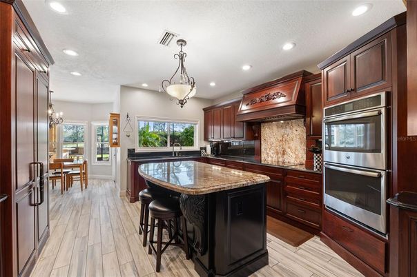 Chandelier, Dining room, Interior, Kitchen, Pendant Lights, Recessed Lighting, Stainless Steel Appliances, Wood Texture Flooring