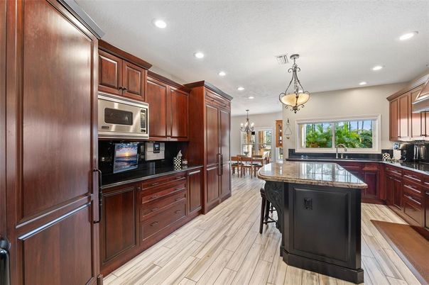 Chandelier, Dining room, Interior, Kitchen, Pendant Lights, Recessed Lighting, Stainless Steel Appliances, Wood Texture Flooring