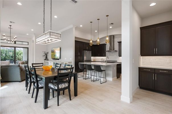 Chandelier, Dining room, Interior, Kitchen, Pendant Lights, Recessed Lighting, Stainless Steel Appliances, Wood Texture Flooring