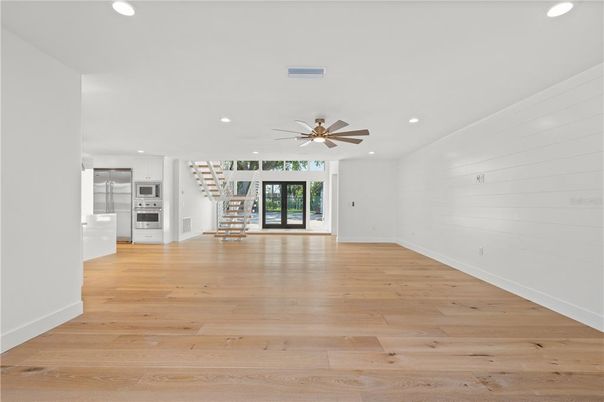 Empty room, Interior, Kitchen, Recessed Lighting, Stainless Steel Appliances, Wood Texture Flooring