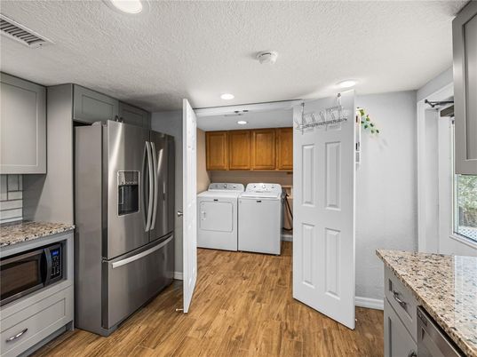 Interior, Kitchen, Recessed Lighting, Stainless Steel Appliances, Washer, Wood Texture Flooring
