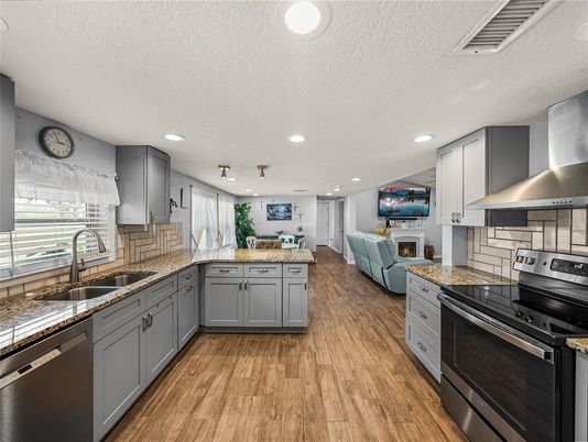 Fireplace, Interior, Kitchen, Living room, Recessed Lighting, Stainless Steel Appliances, Wood Texture Flooring