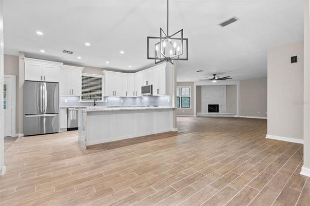 Fireplace, Interior, Kitchen, Pendant Lights, Recessed Lighting, Stainless Steel Appliances, Wood Texture Flooring