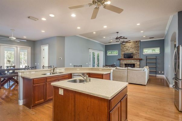 Dining room, Fireplace, Interior, Kitchen, Living room, Recessed Lighting, Stone Walls, Wood Texture Flooring