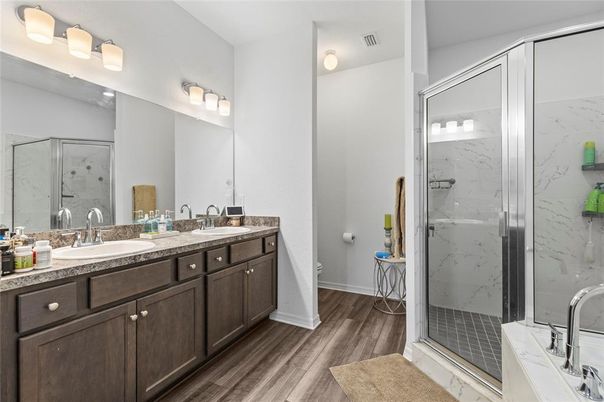 Bathroom, Dual Sink Vanities, Glass Shower, Interior, Marble Walls, Wood Texture Flooring