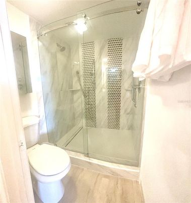 Bathroom, Glass Shower, Interior, Marble Walls, Wood Texture Flooring